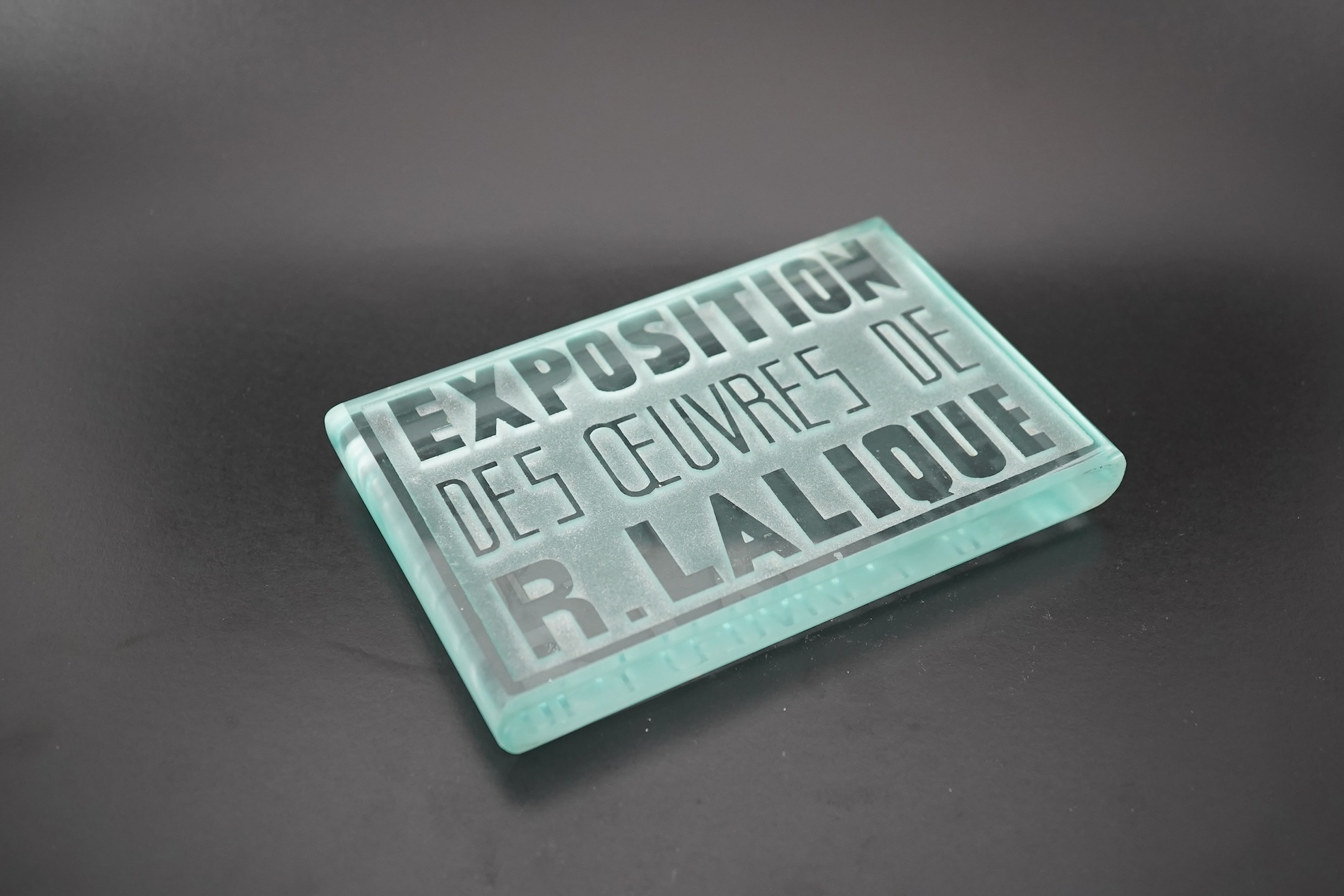 Lalique: A glass advertising plaque 'EXPOSITION DES ŒUVRES DE R.LALIQUE'